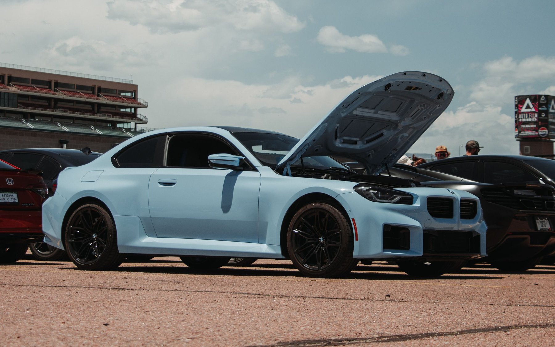Light blue BMW M2 G87 with its bonnet open at a car meet