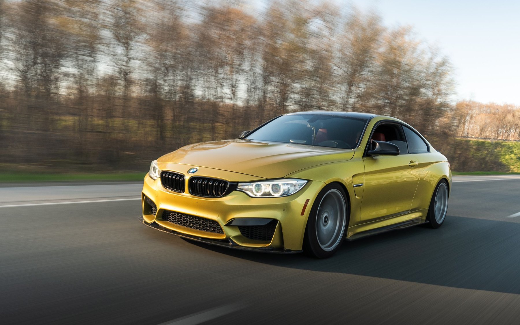 Austin Yellow BMW M4 F82 driving on an open road