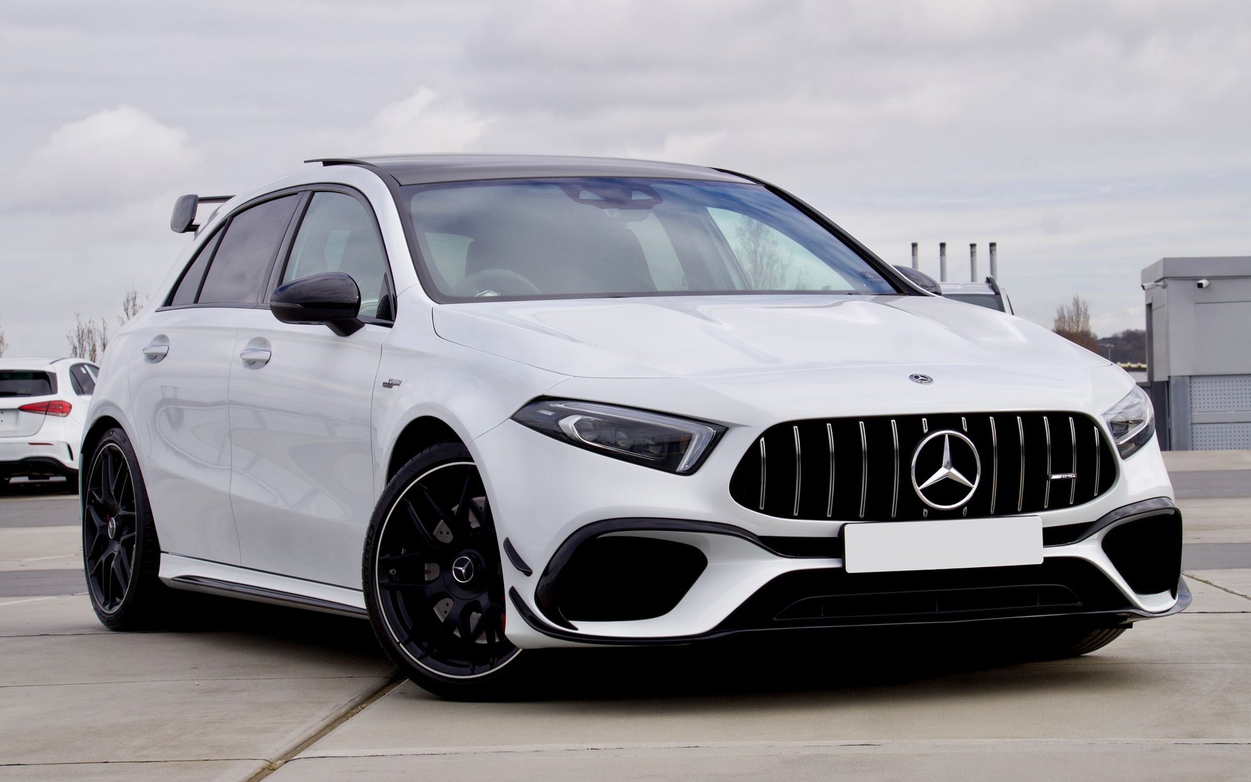 White Mercedes-AMG A45 S W177 with the Panamericana grille, parked on a rooftop