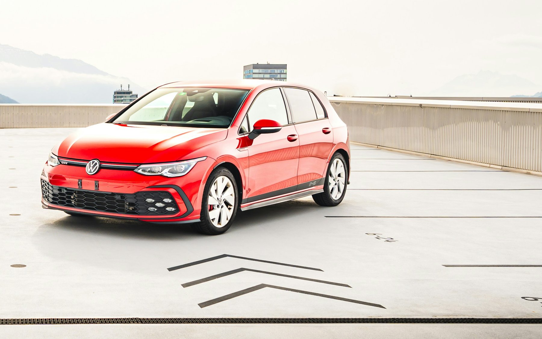 Red Volkswagen Golf GTI Mk8 on a rooftop car park