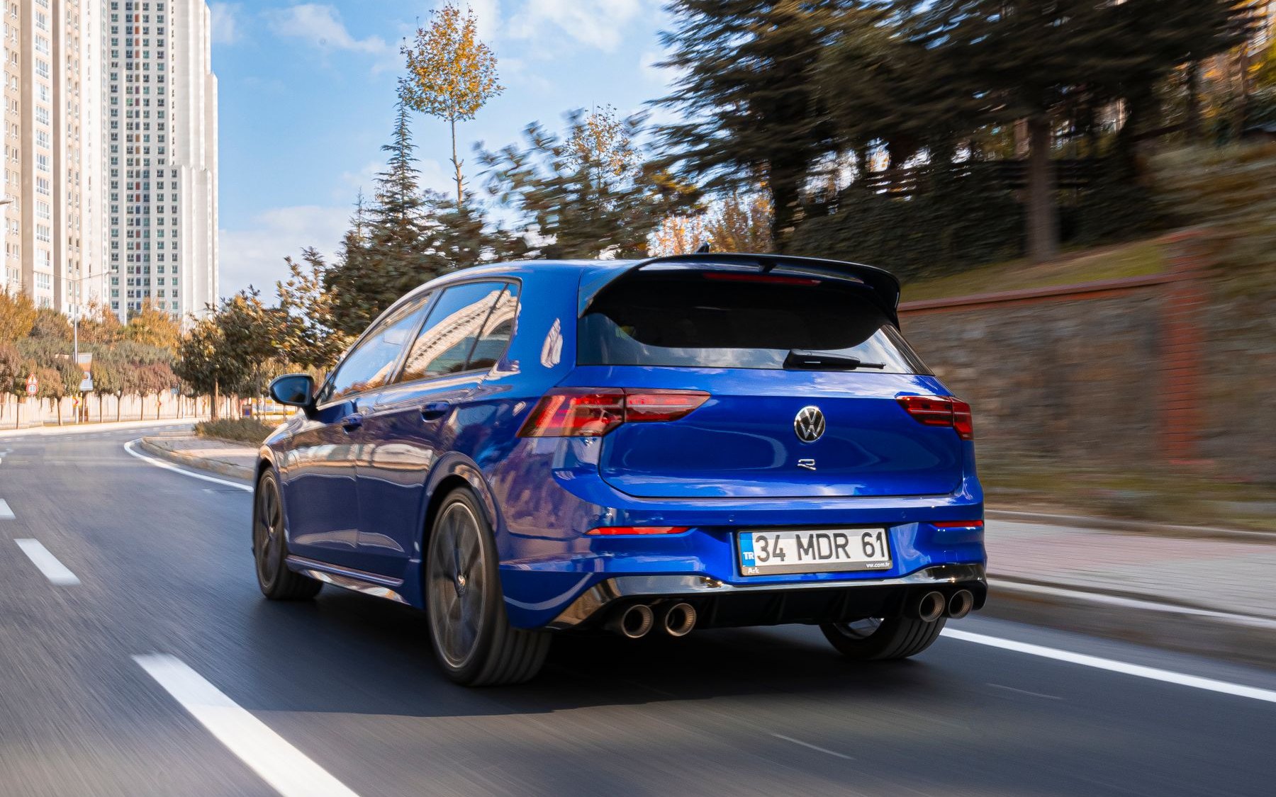 Blue Volkswagen Golf R Mk8 driving on a city road